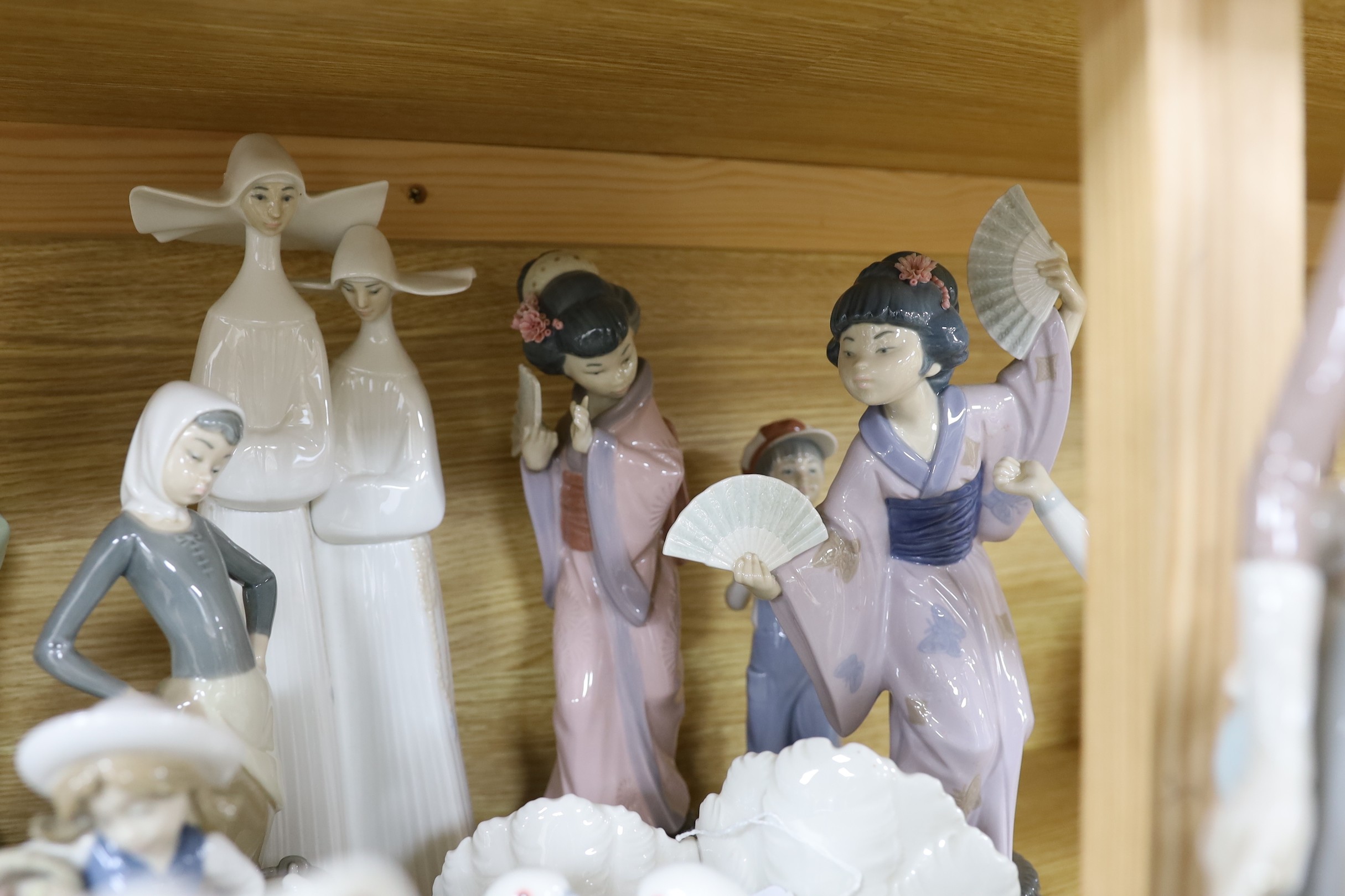 A selection of fifteen Lladro figures, tallest 35cm